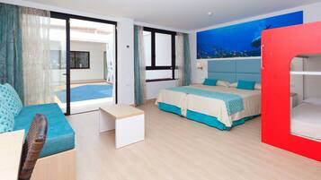 A modern hotel room with a bed, a sofa, a small table, and a red bunk bed.