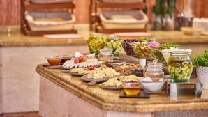 A buffet table with various food items and condiments.