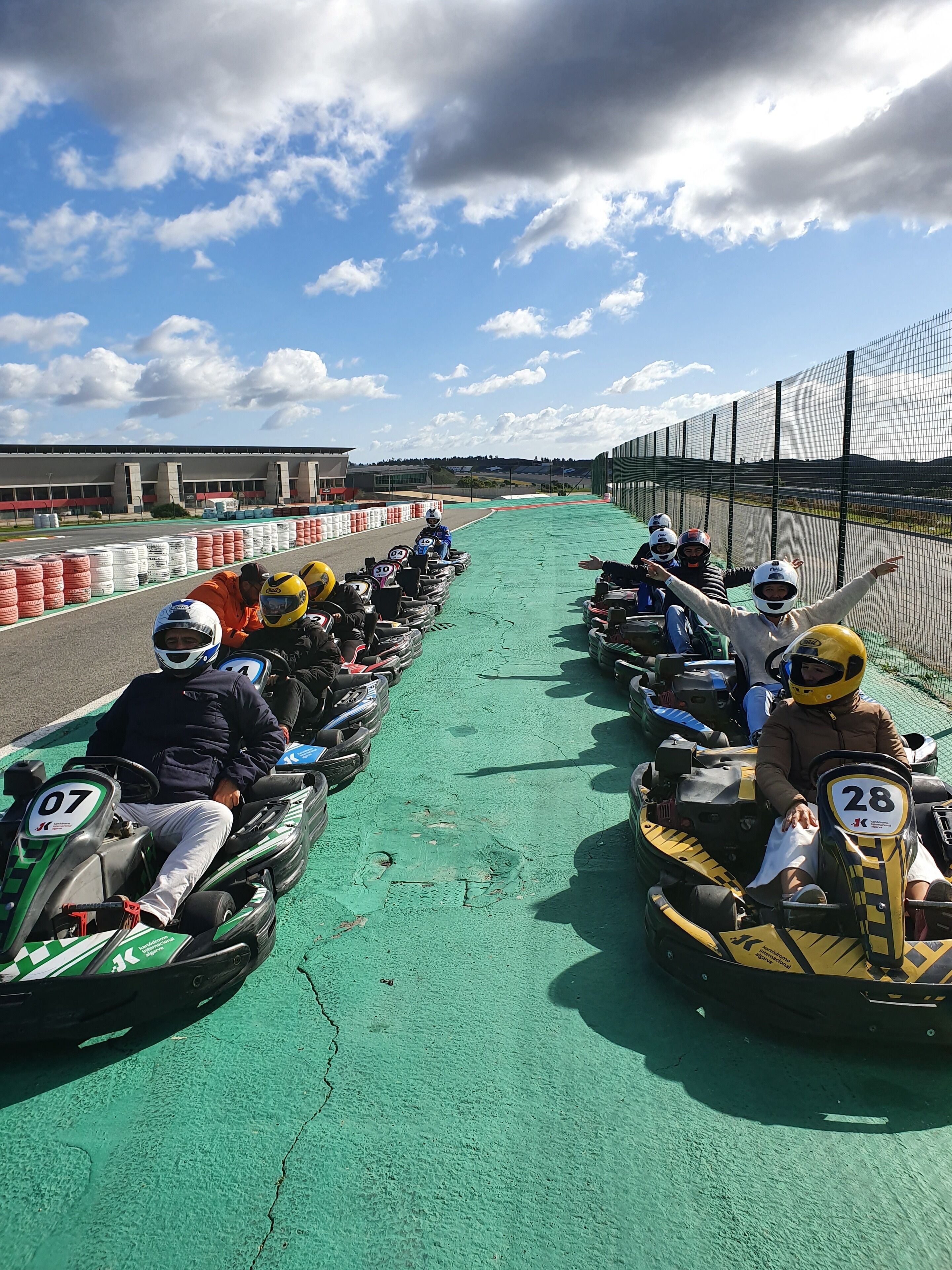 Una pista de karts con varios karts alineados, numerados del 07 al 28, y superficie de la pista en color verde.