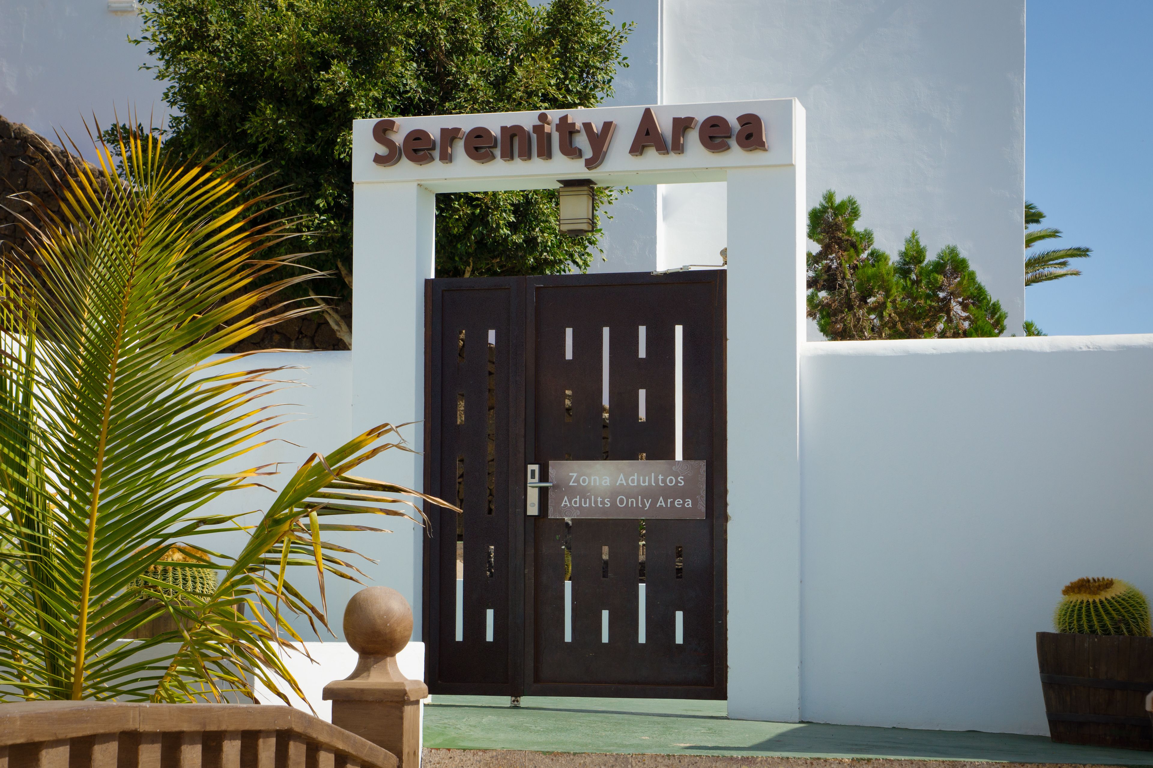 A gated entrance labeled "Serenity Area" with a sign indicating it is an "Adults Only Area."