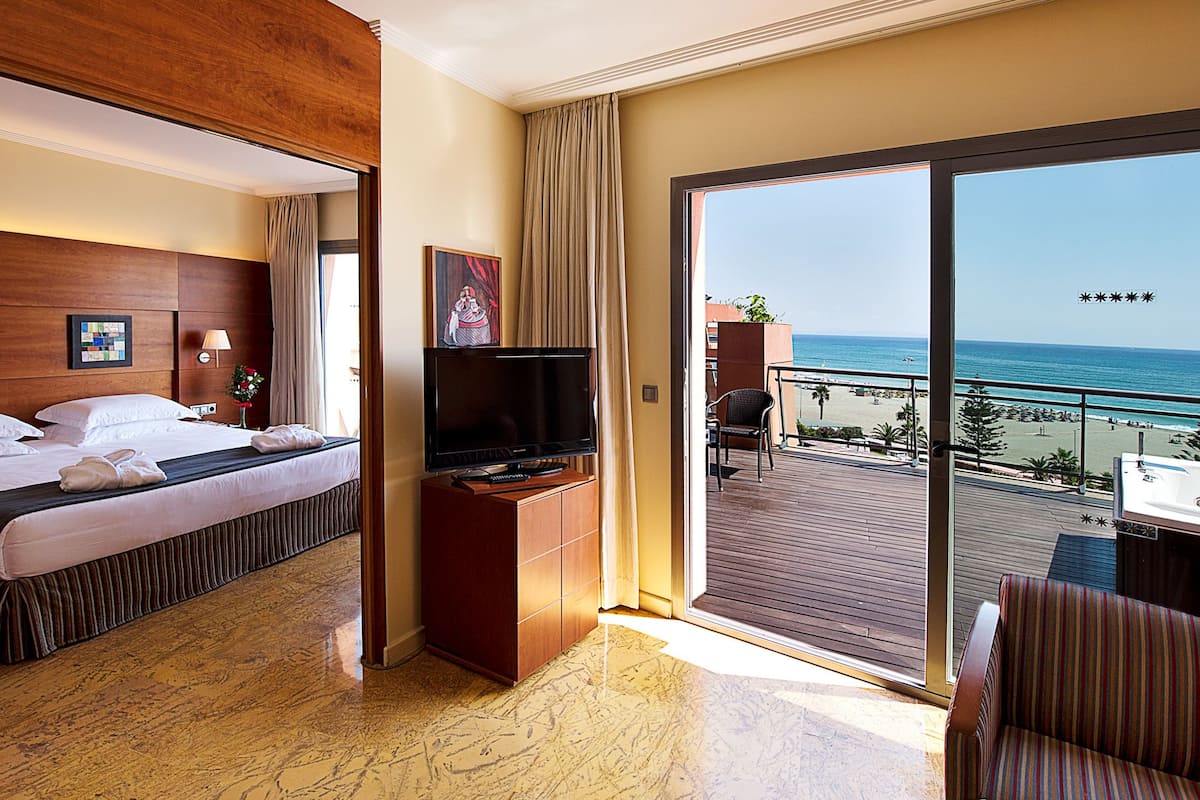 elite suite, jetted tub, sea view | 1 bedroom, minibar, in-room safe, desk