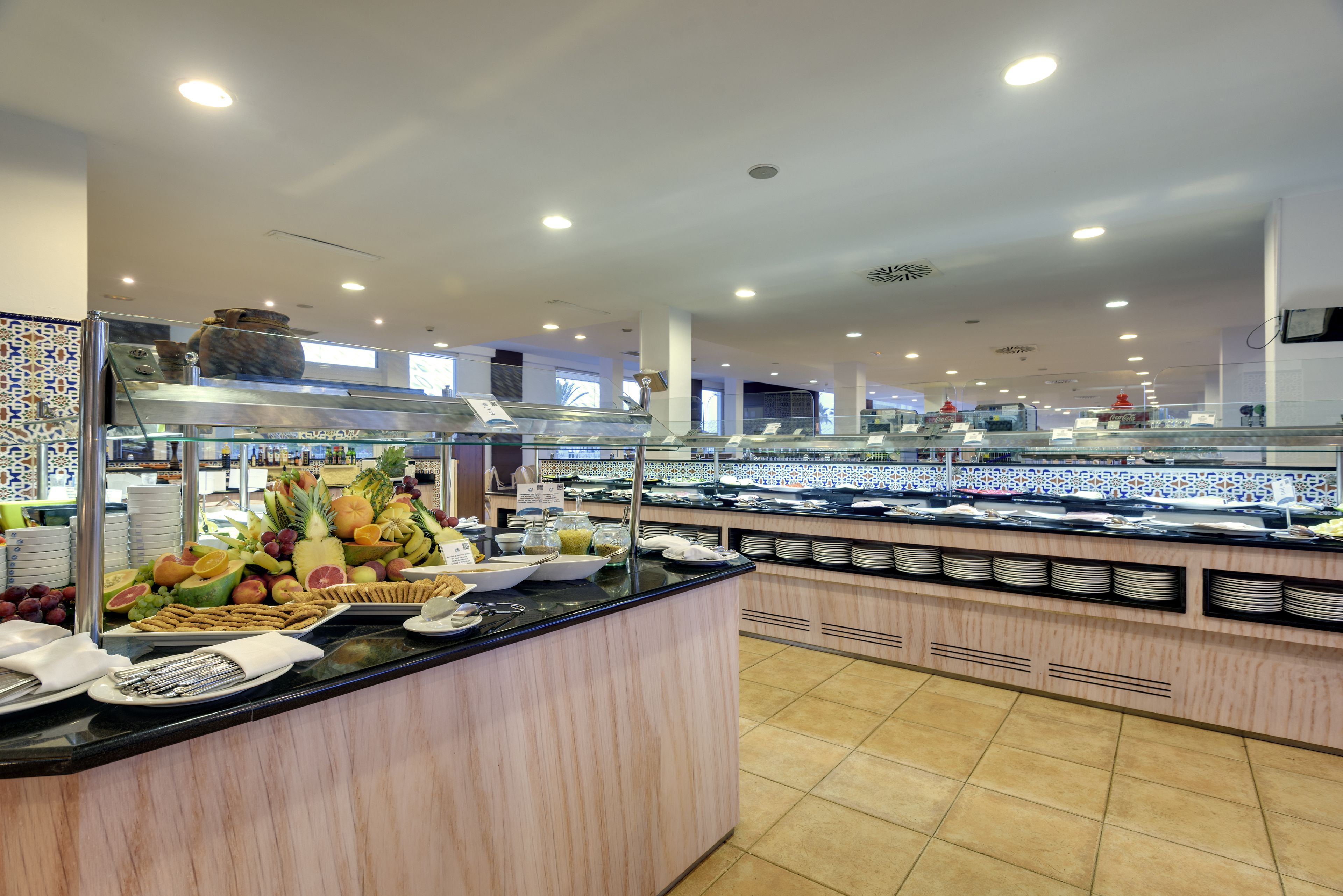 A buffet area with various food items and a self-service counter.