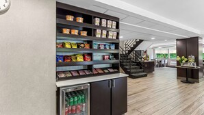 A snack display with various packaged foods and a refrigerated section with drinks. - Best Western West Lebanon-Hanover Hotel (West Lebanon)