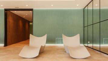 Relax in a stylish seating area with two curved chairs and a spacious floor.