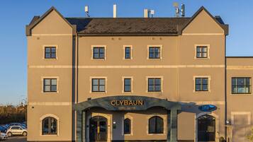 A hotel with a prominent sign reading 'Clybaun Hotel Galway' and a health and fitness center sign.
