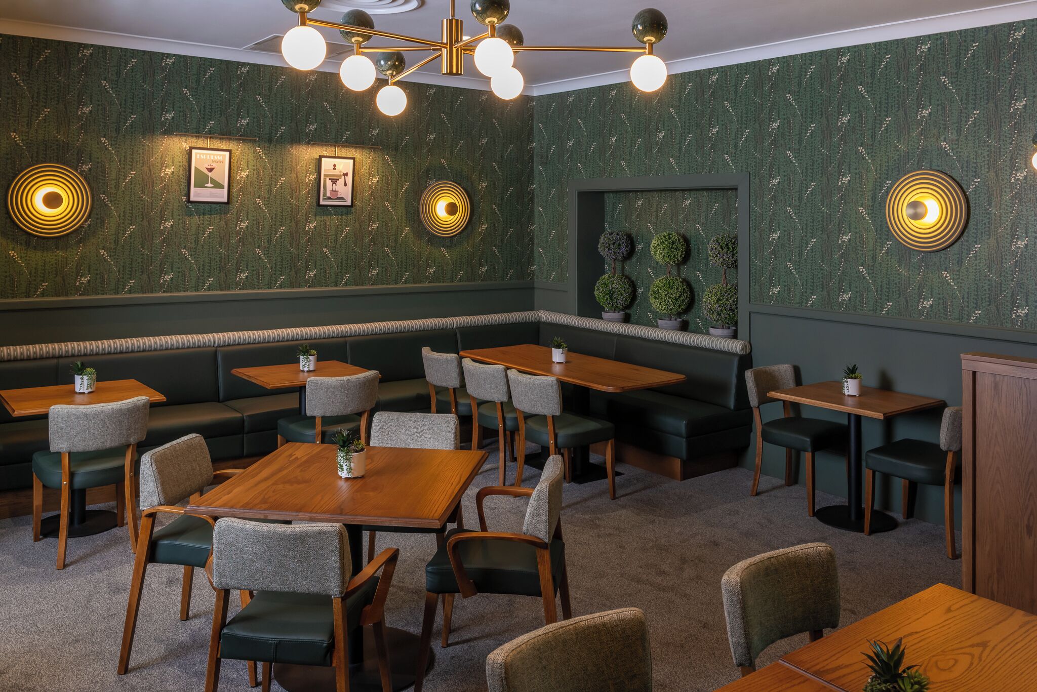 A restaurant interior with booths, tables, and a patterned wall.