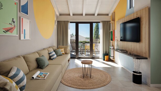 A modern living room with a sofa, a round table, a ceiling fan, and a TV mounted on the wall. - Sunny Porec Residence (Porec)