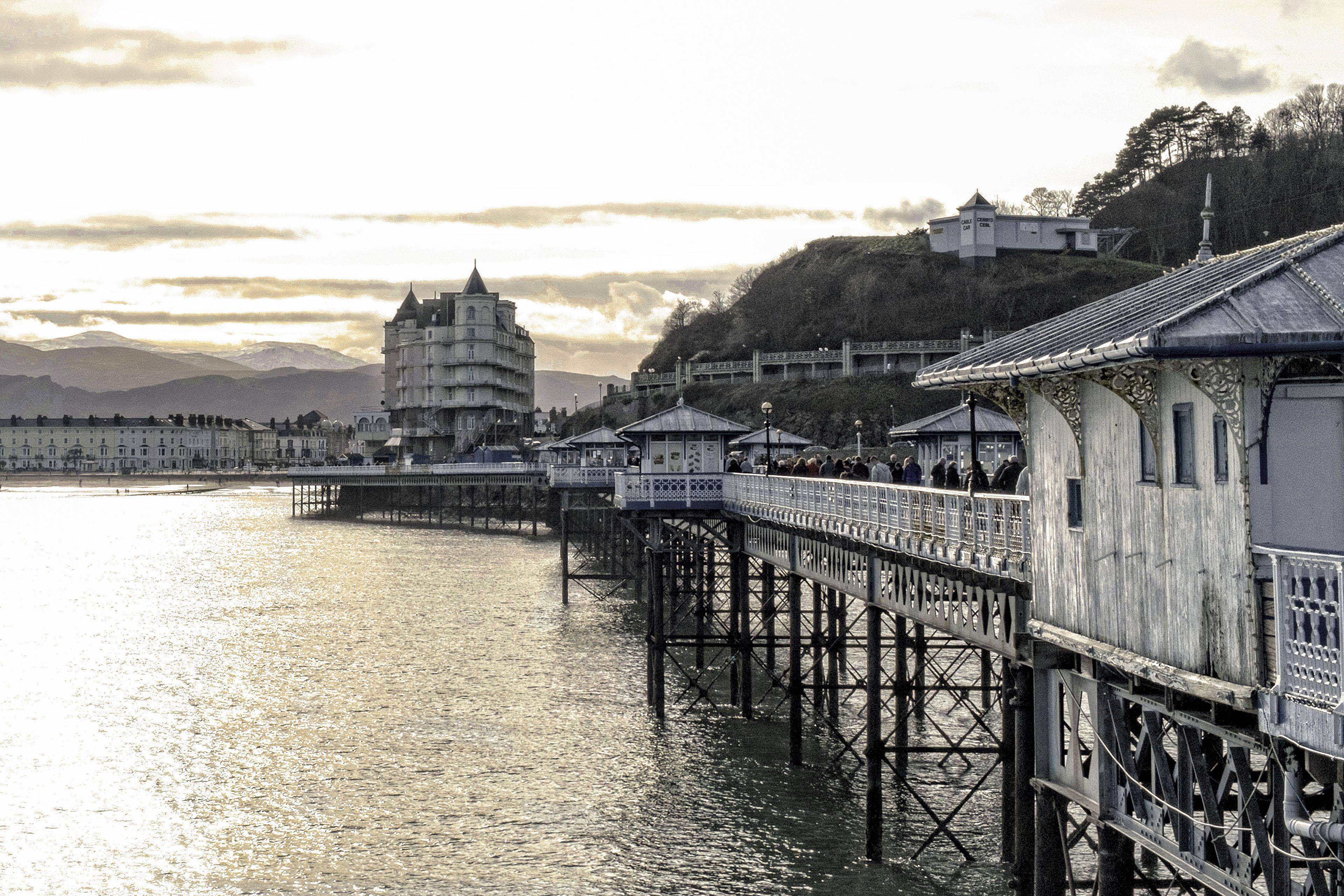A waterfront pier with a traditional pagoda-style building in the background.