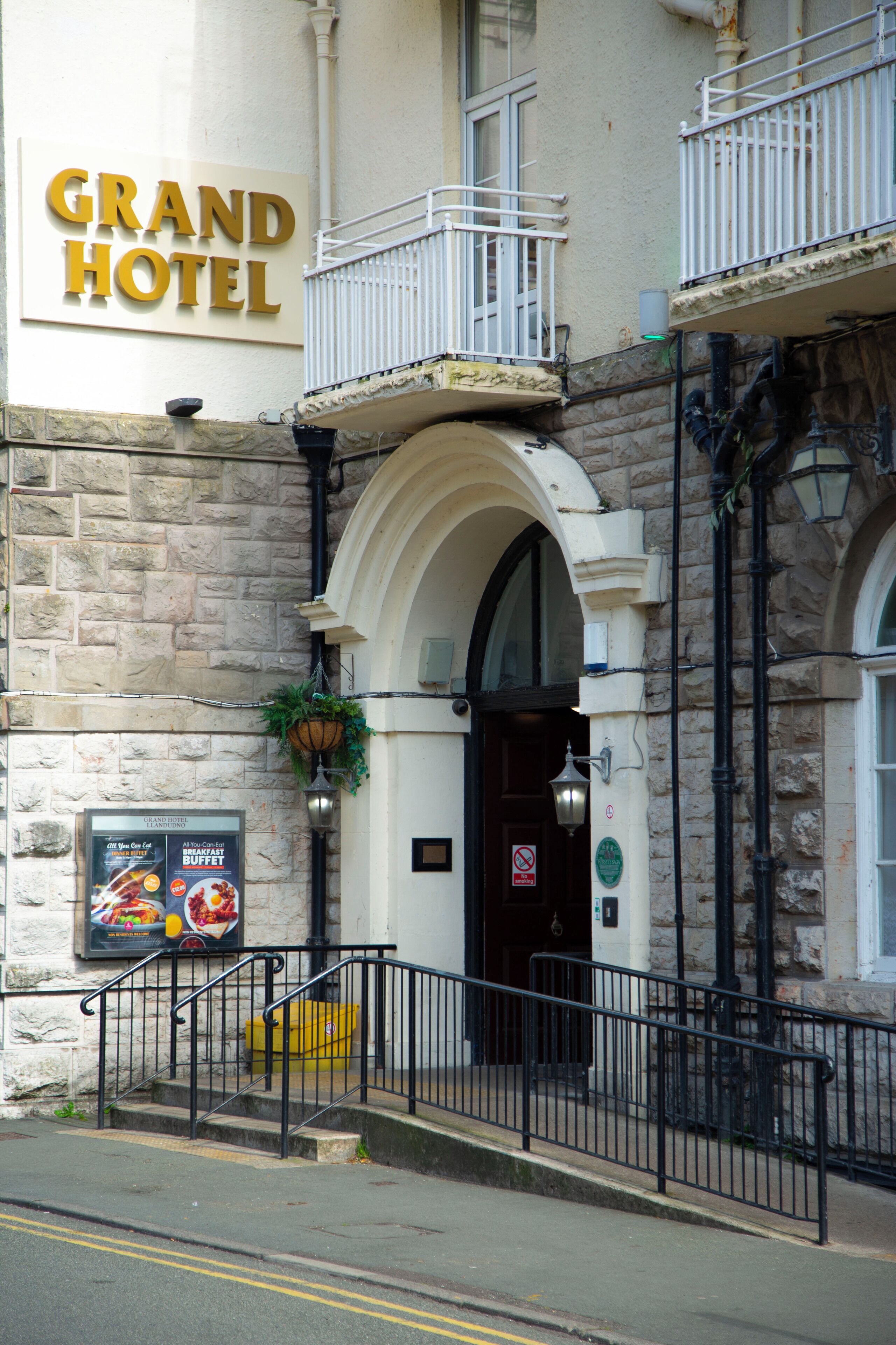 A hotel entrance with a sign reading "GRAND HOTEL".