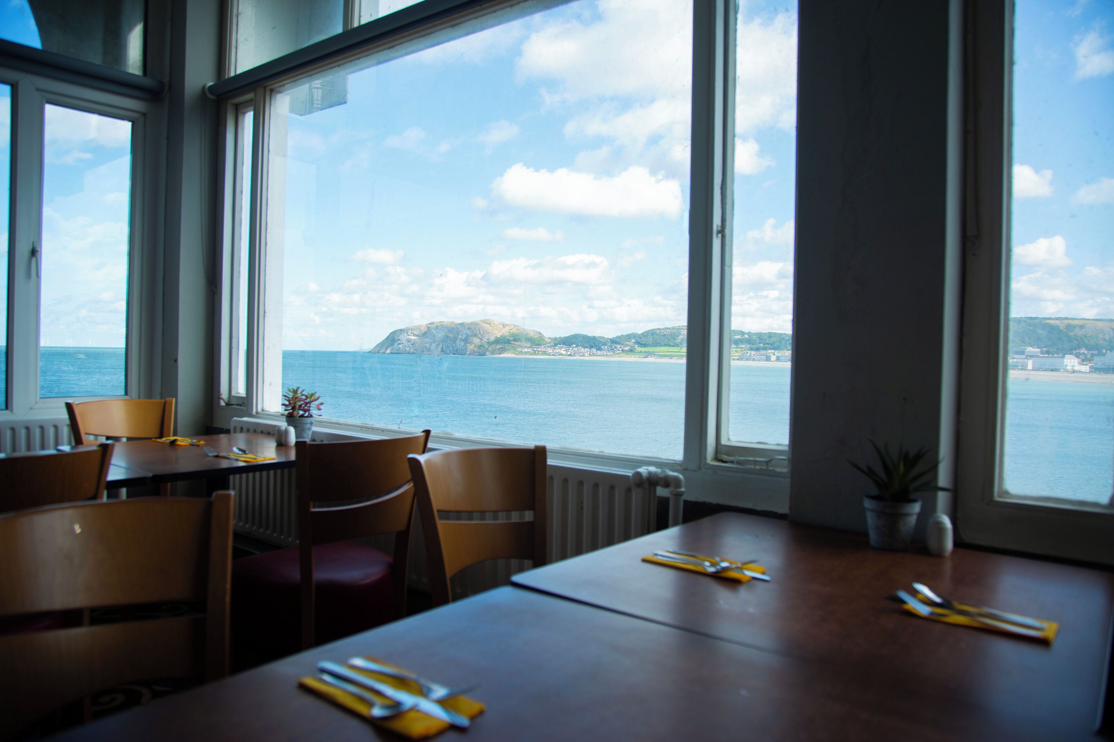 Ein Essbereich mit Blick auf das Meer und eine entfernte Insel.