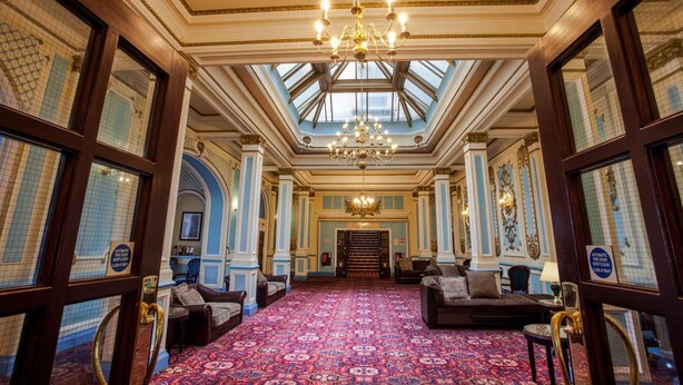 A grand lobby with a high ceiling, ornate chandeliers, and a patterned carpet. - The Metropole Hotel (Blackpool)