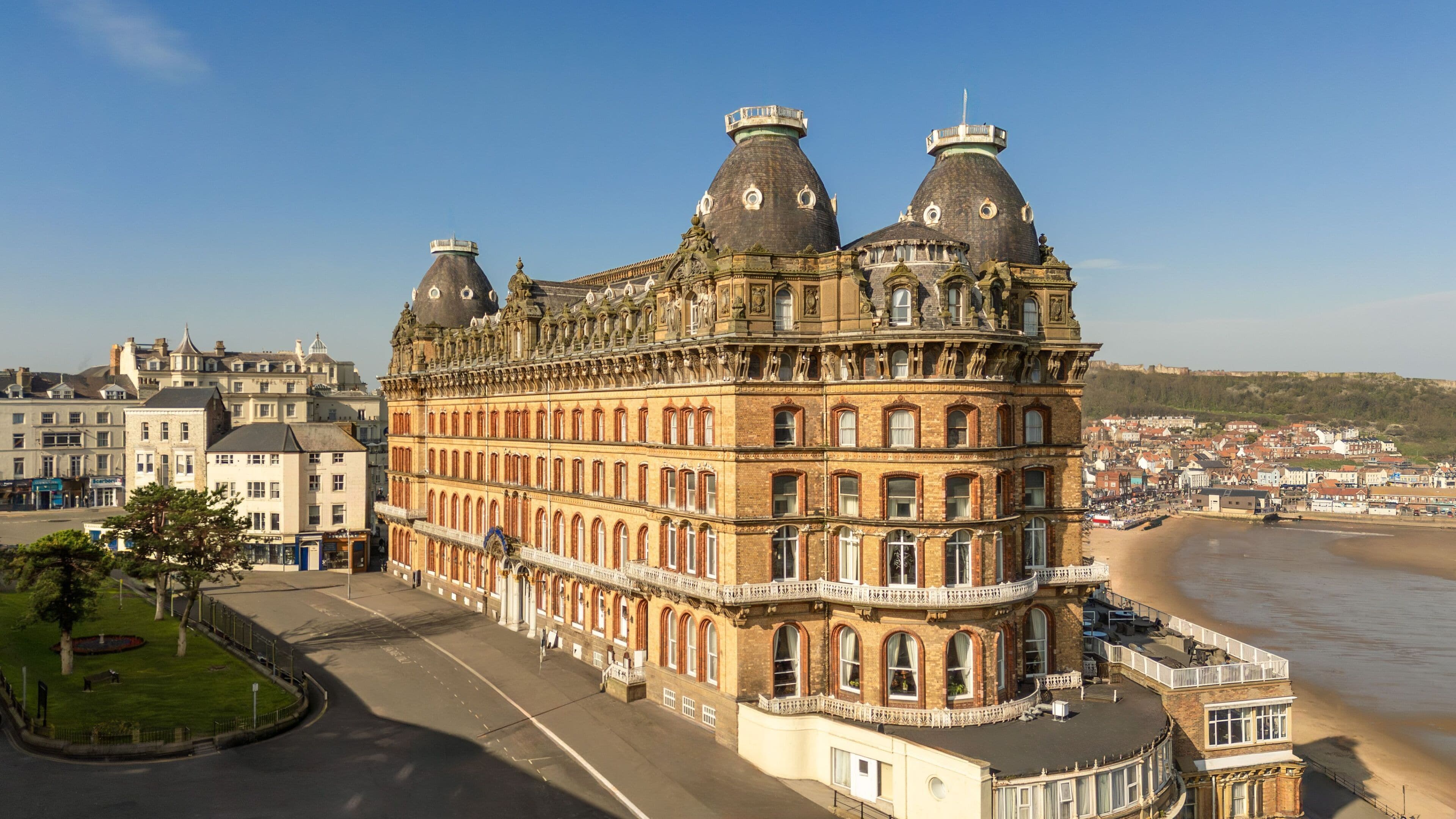 A historic building with ornate architecture, large windows, and a prominent corner turret.