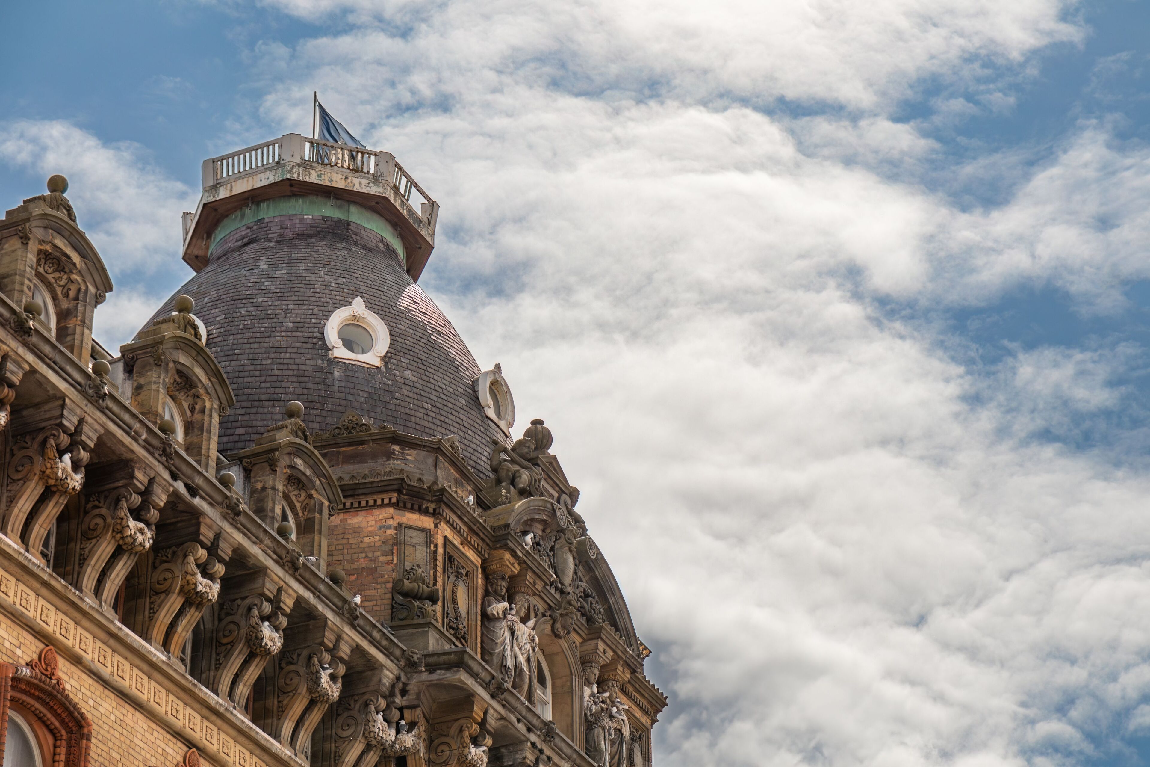 A historic building with ornate architectural details, including a prominent dome and intricate stone carvings.