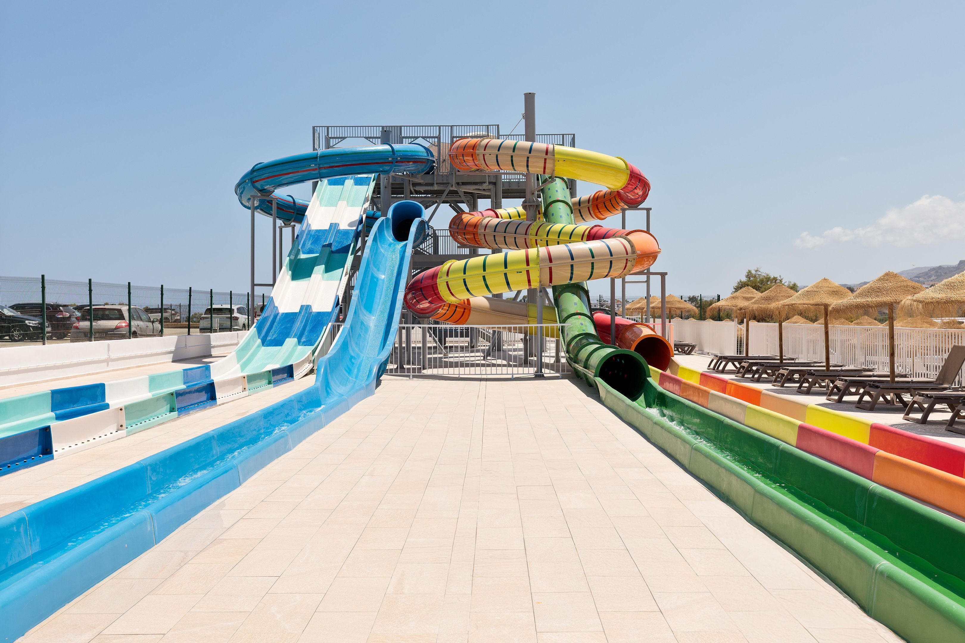 A water park with multiple slides and a pool area.