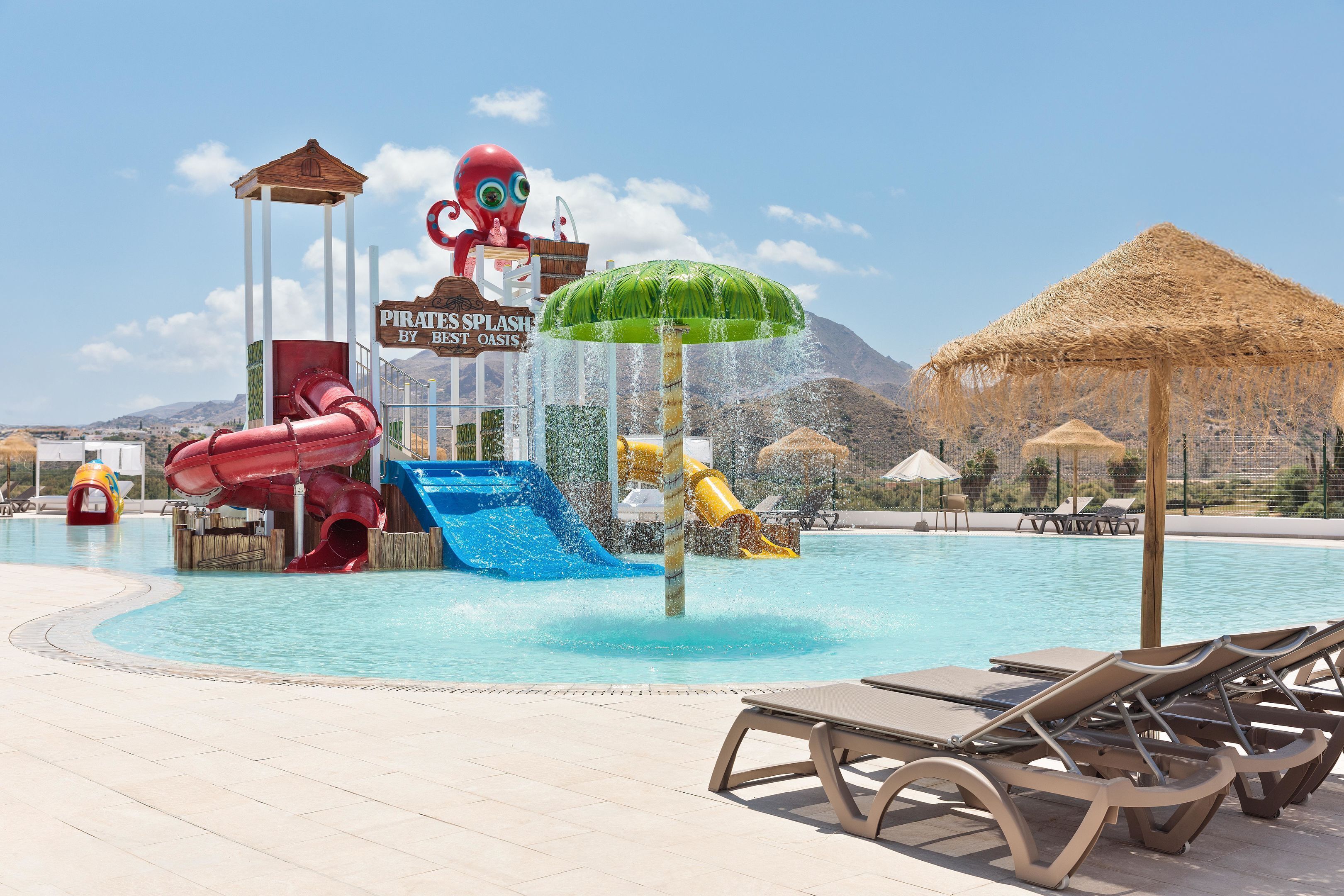 A water park with slides and a sign reading "Pirates Splash by Best Oasis".