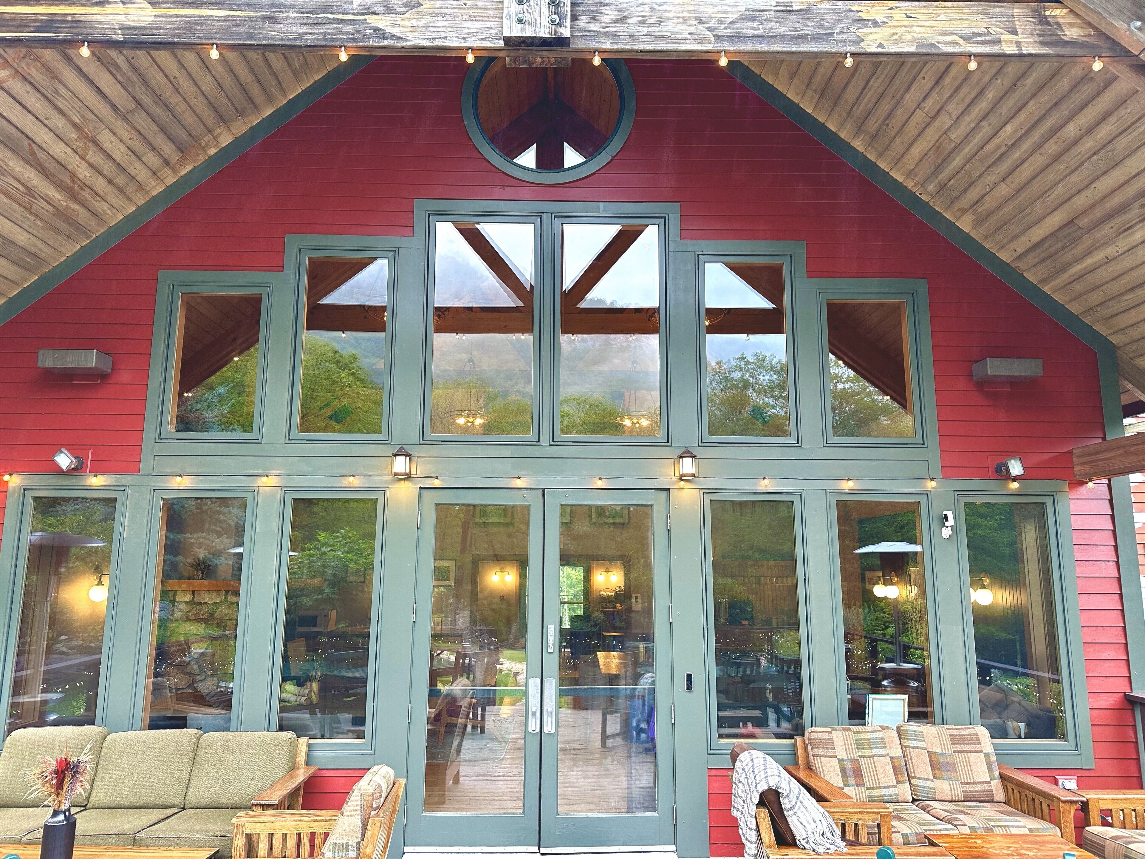 A large, red building with multiple windows and a covered patio area.