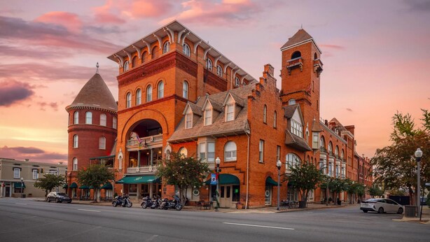 A historic building with a prominent tower, arched entrance, and a balcony. - Windsor Hotel, an Ascend Collection Hotel (Americus)