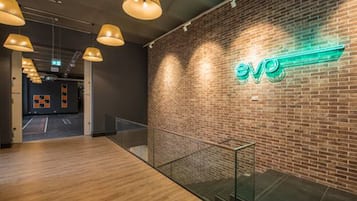 A modern interior with a brick wall and a neon sign.
