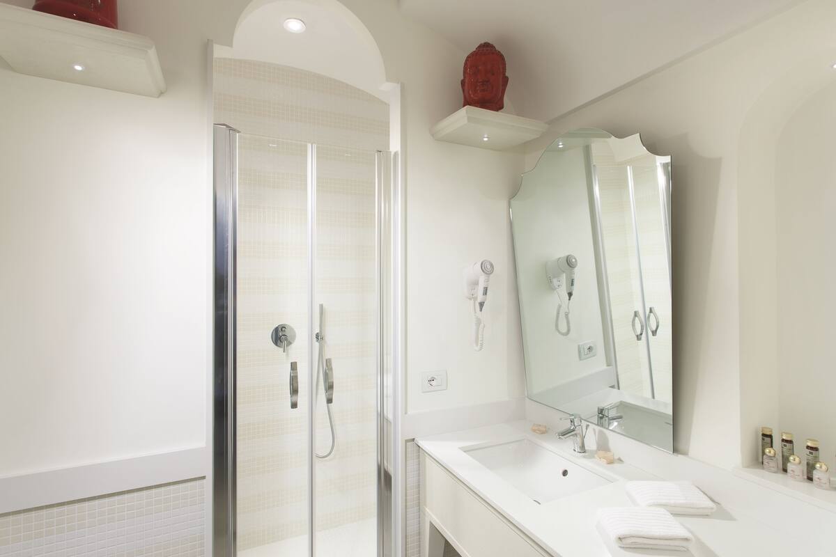 hair dryer, slippers, bidet, towels