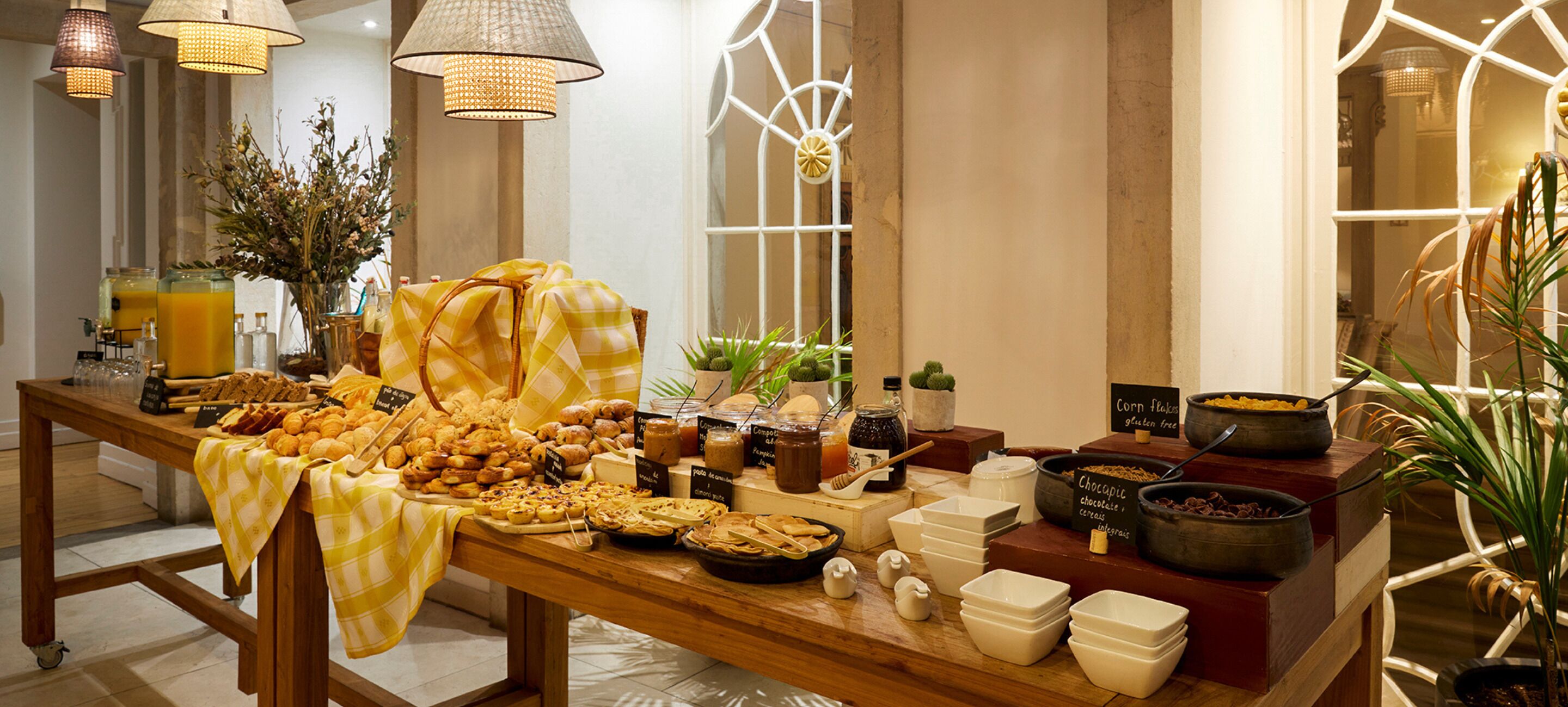 A buffet table with various food items and serving utensils.
