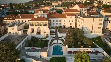 Relax in a serene courtyard surrounded by lush greenery and classic European architecture.