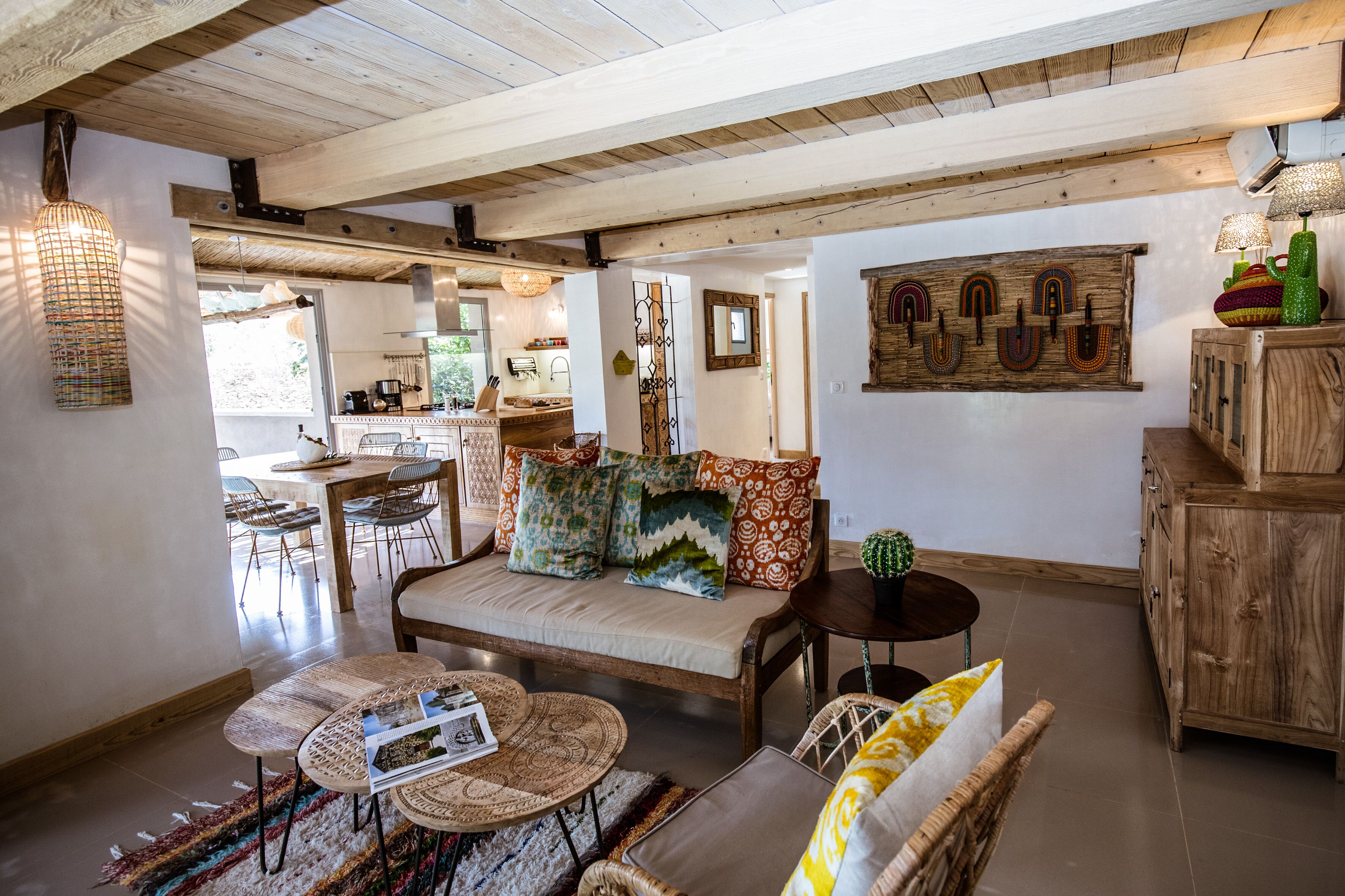 A cozy living area with a sofa, coffee table, and a dining table.