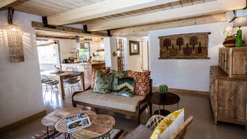 A cozy living area with a sofa, coffee table, and a dining table.