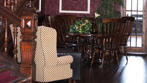 A grand staircase with a wooden handrail and a chandelier. - Royal Exeter Hotel (Bournemouth)