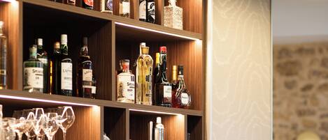 A bar area with shelves of liquor bottles and glasses.