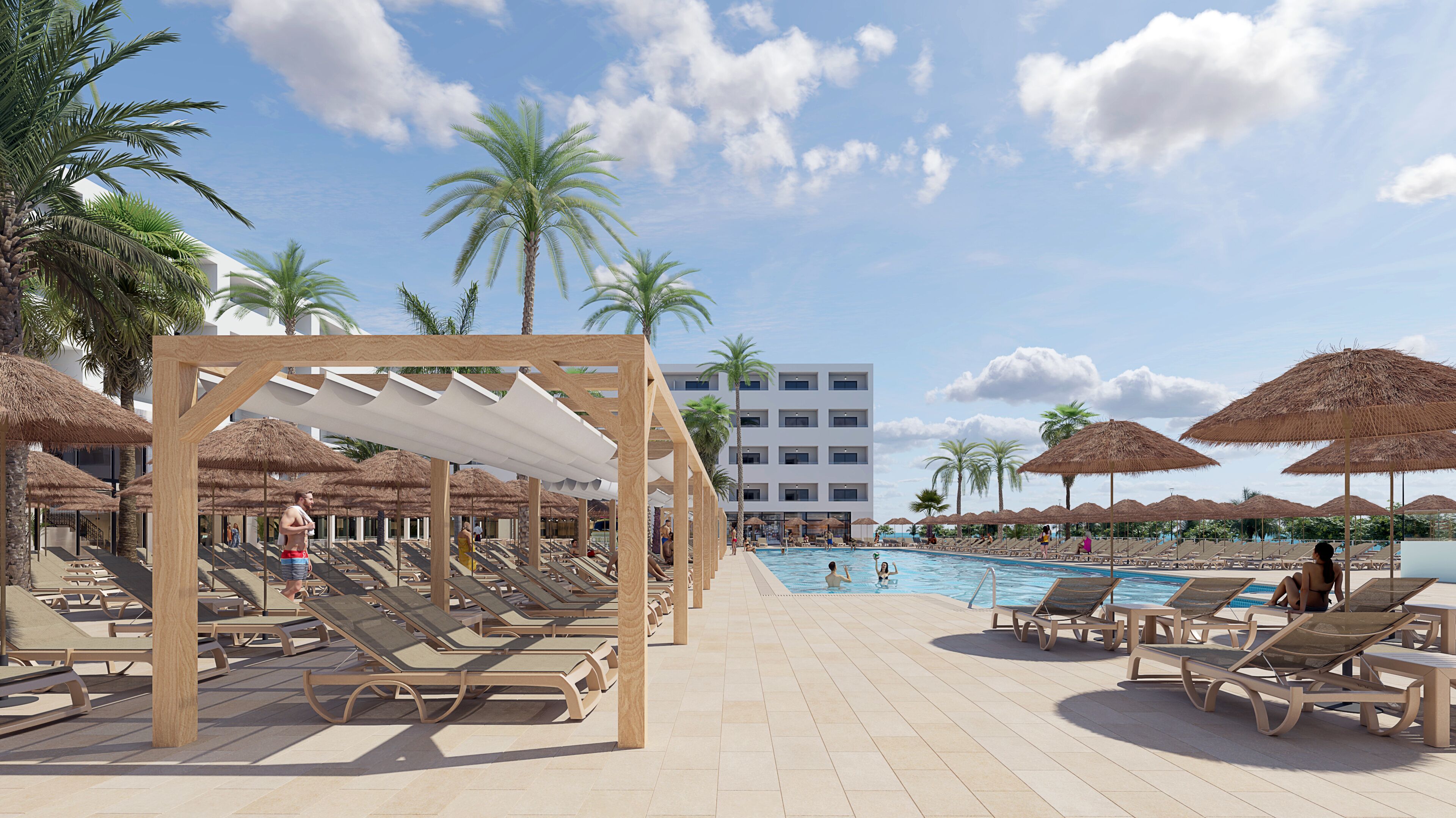 A poolside area with sun loungers, thatched umbrellas, and a clear blue sky.