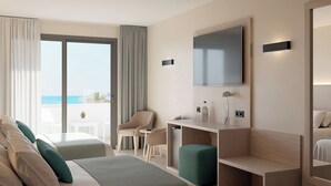 A hotel room with a bed, two chairs, a desk, a TV, and a view of the sea. - Hotel Best Mojácar (Mojacar)