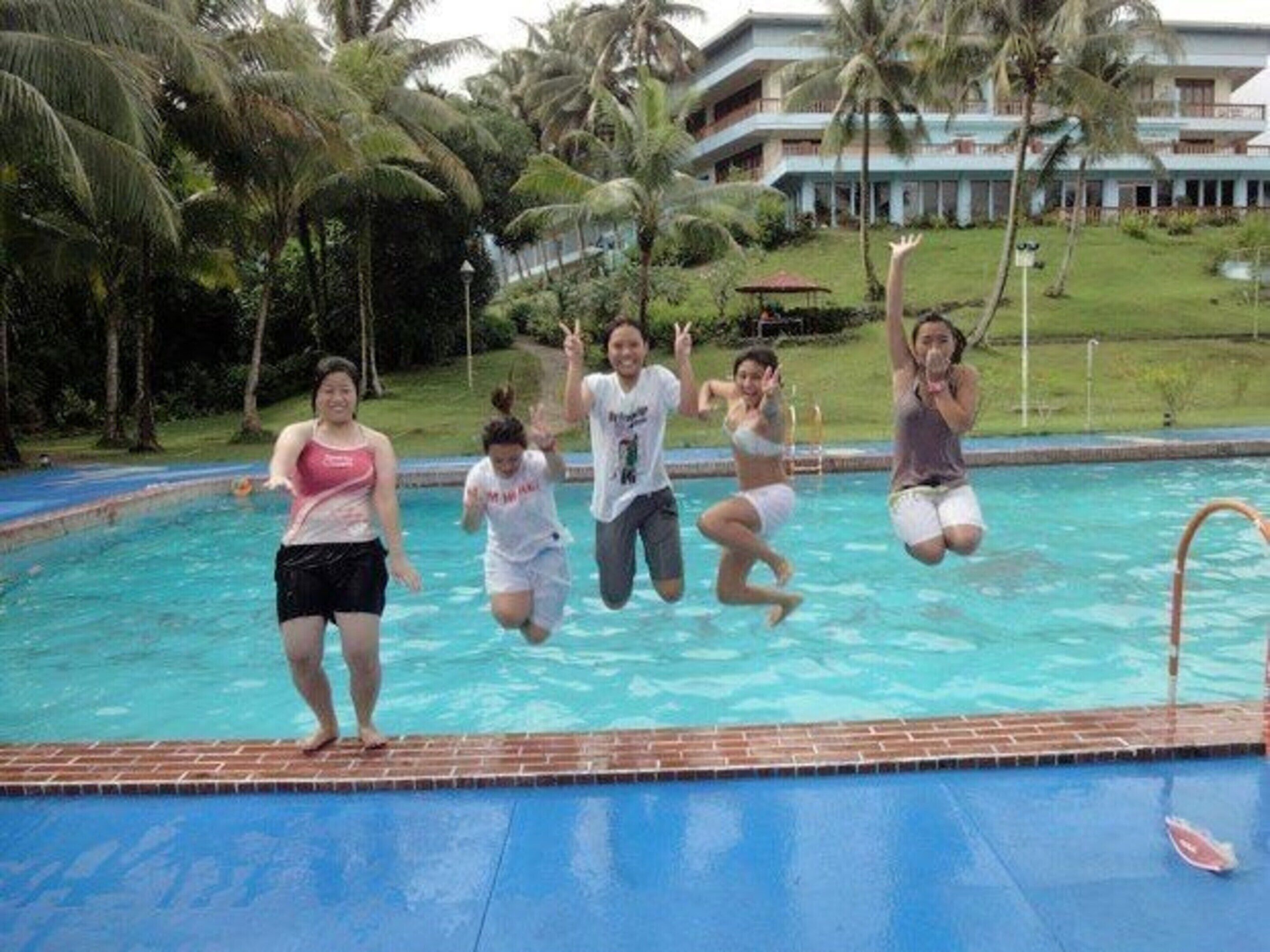 A swimming pool with a brick edge and a clear blue water surface.