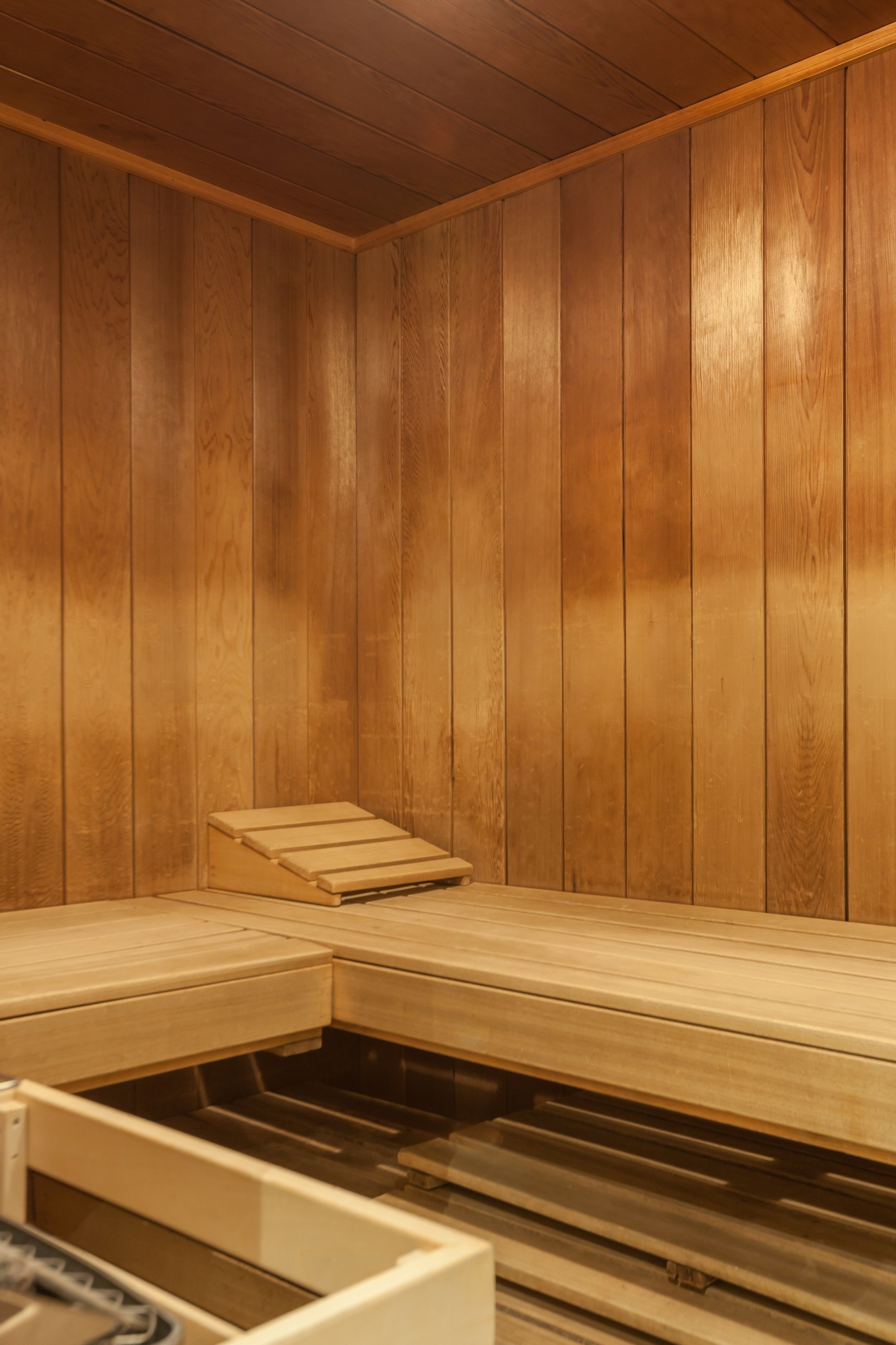 A sauna room with wooden walls and benches.