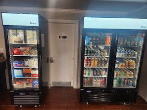 Two Aresta branded vending machines with snacks and beverages. - Economy Inn and Suites (Tulsa)