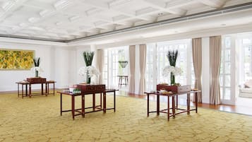 Relax in a stylish room with a high ceiling, featuring a classic grid pattern and elegant decor.