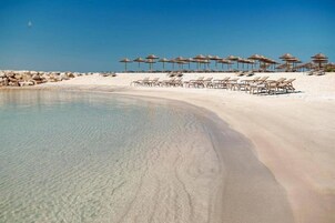 On the beach, free beach cabanas, sun loungers, beach volleyball