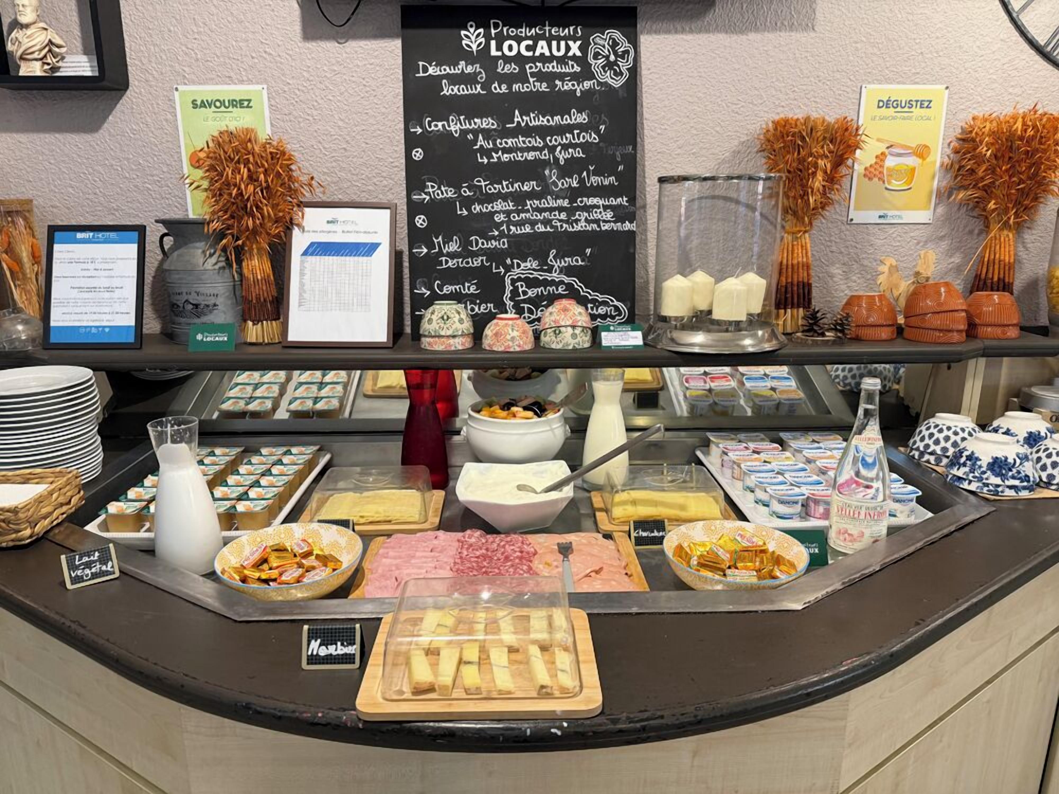 A breakfast buffet with various food items, a chalkboard menu, and decorative elements.