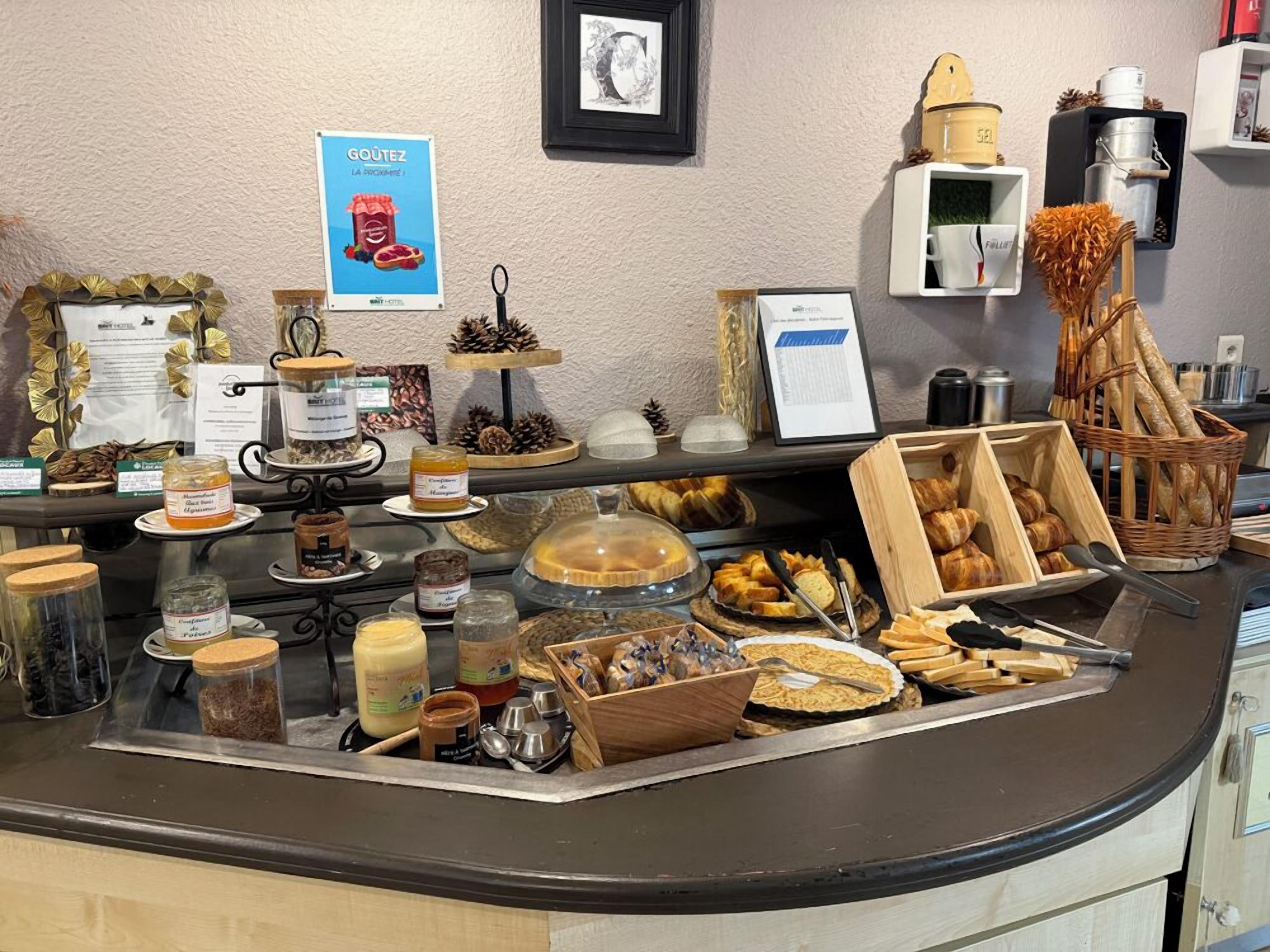 A breakfast buffet with various food items, condiments, and utensils.