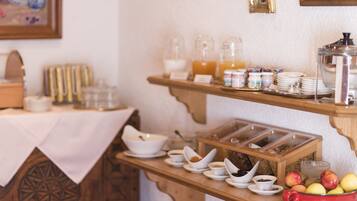 A breakfast buffet with various food items and beverages.