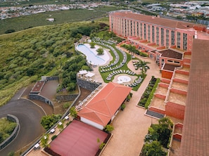 A hotel with a swimming pool, a landscaped garden, and a large building with multiple balconies. - Hotel Las Aguilas Tenerife, Affiliated by Melia (Puerto de la Cruz)
