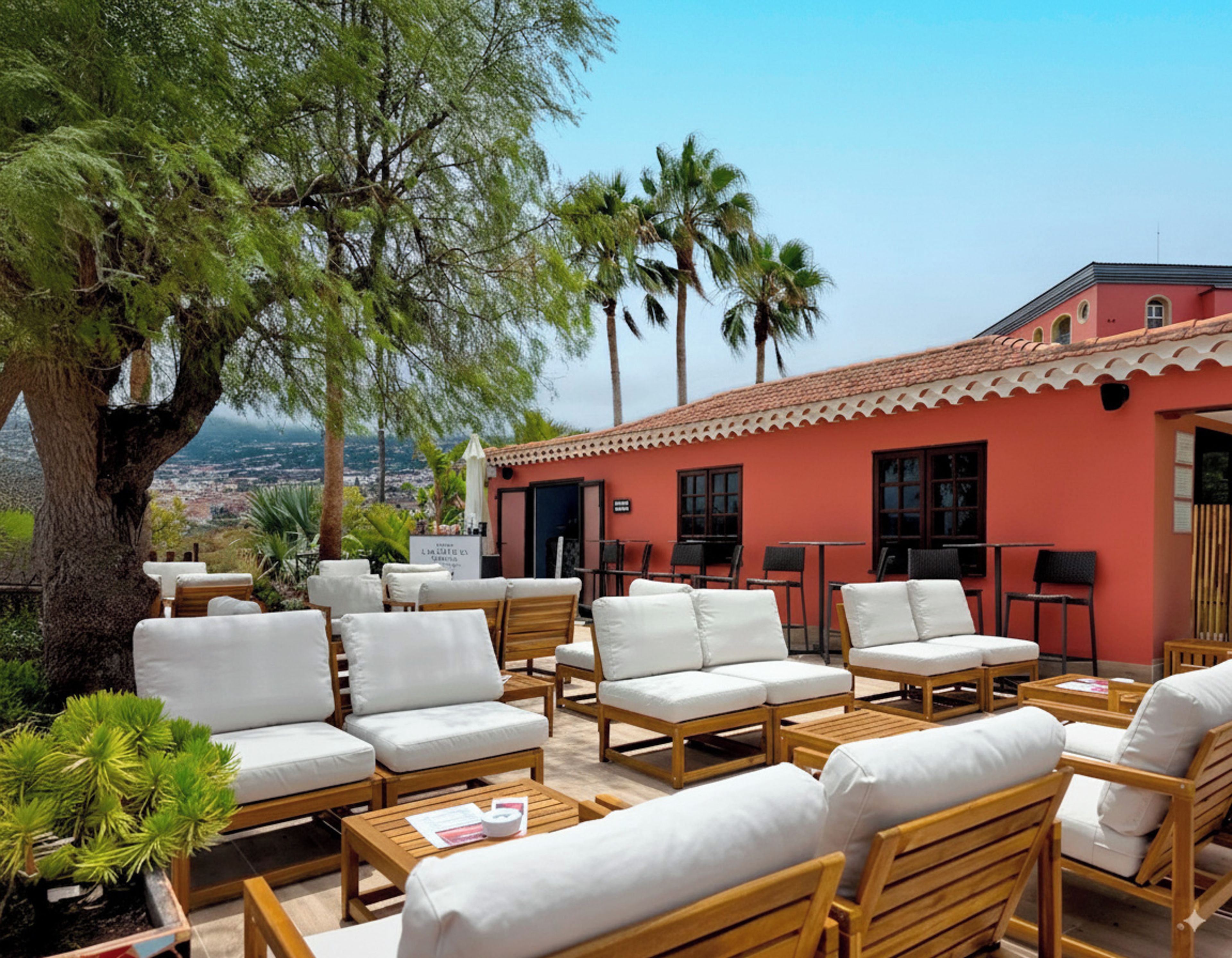 A terrace with outdoor seating and a view of the city.