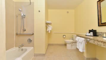 A bathroom with a bathtub, toilet, and shower.