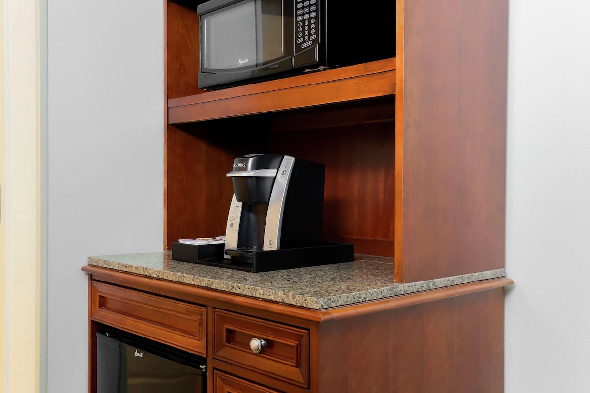 A kitchen with a microwave, coffee maker, and a dishwasher.