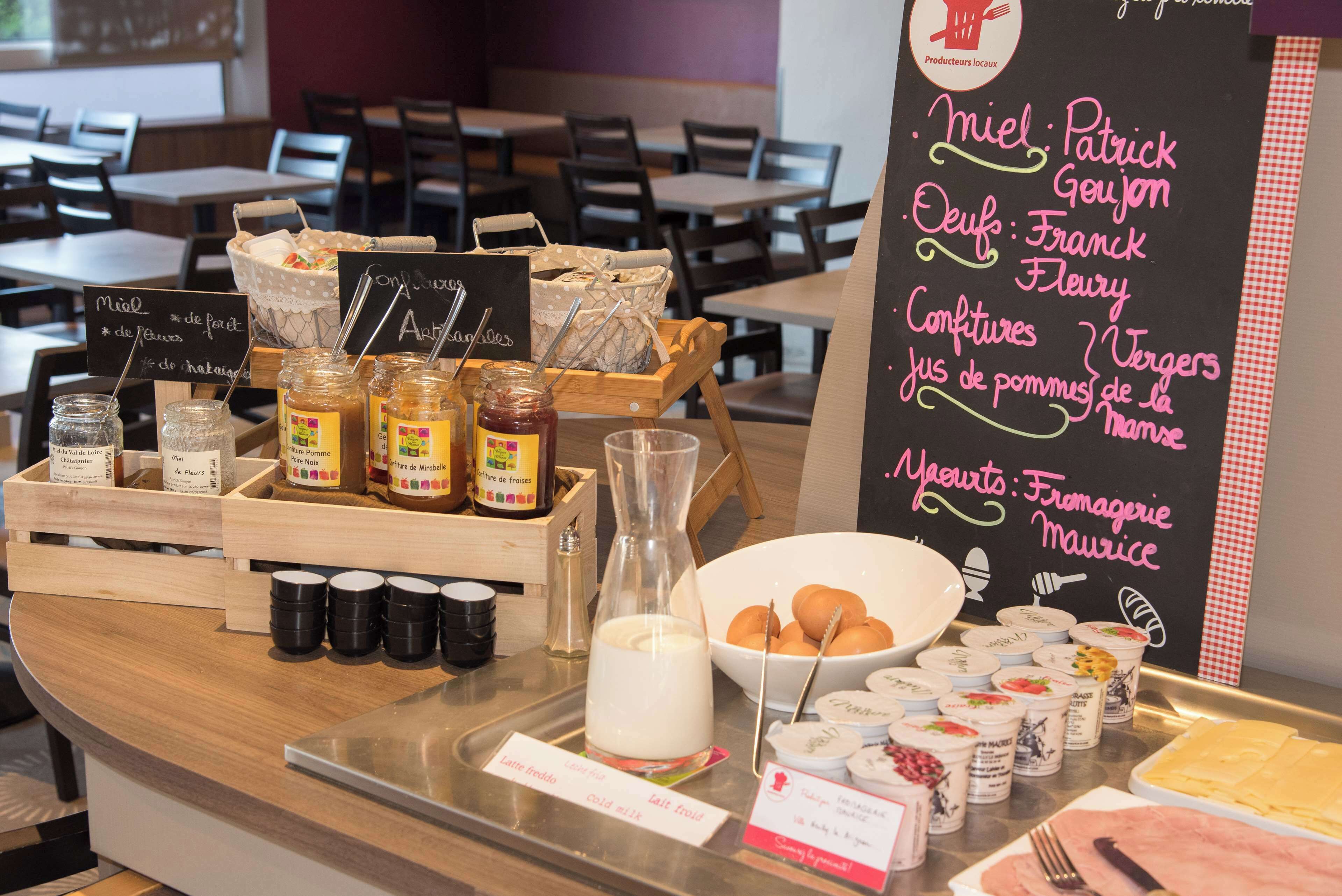 A breakfast buffet with various food items and condiments.