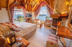 Panoramic Suite | Living room | 42-inch plasma TV with cable channels, TV, fireplace