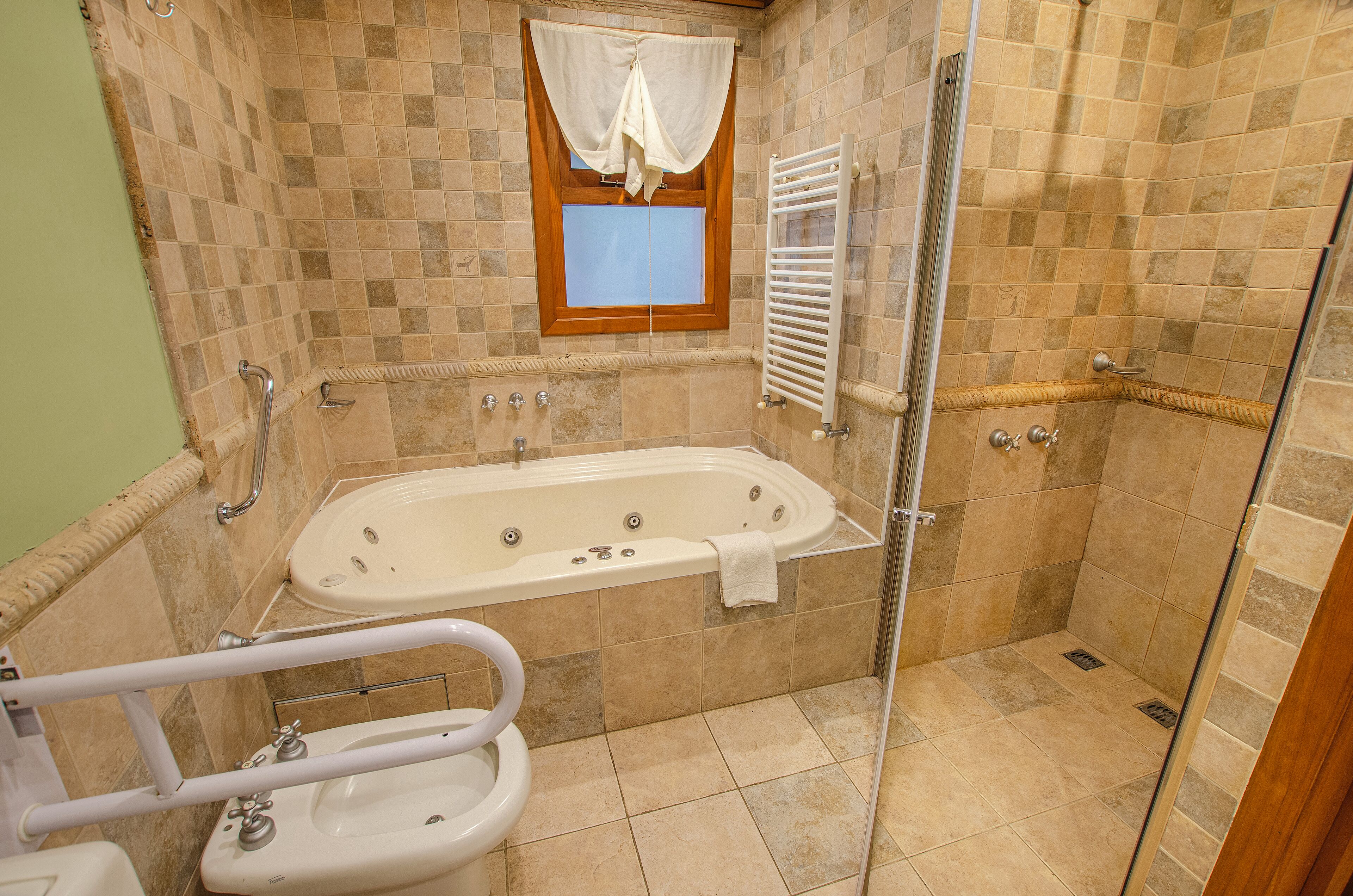 A bathroom with a bathtub, a shower, and a toilet.