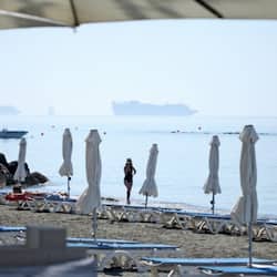 On the beach, sun-loungers, beach towels, beach bar