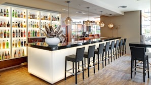 A bar area with a long counter and multiple seating options. - Protur Turó Pins Hotel (Capdepera)