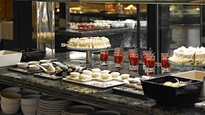 A buffet with various desserts and beverages, including a cake, cupcakes, and fruit cups. - Protur Turó Pins Hotel (Capdepera)