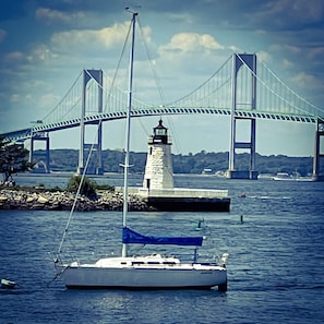 A lighthouse near a bridge over water. - Almondy Inn (Newport)